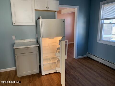 128 Hamilton Ave, Seaside Heights, NJ 08751 - kitchen featuring freestanding refrigerator, dark wood finished floors, light countertops, baseboard heating, and white cabinets