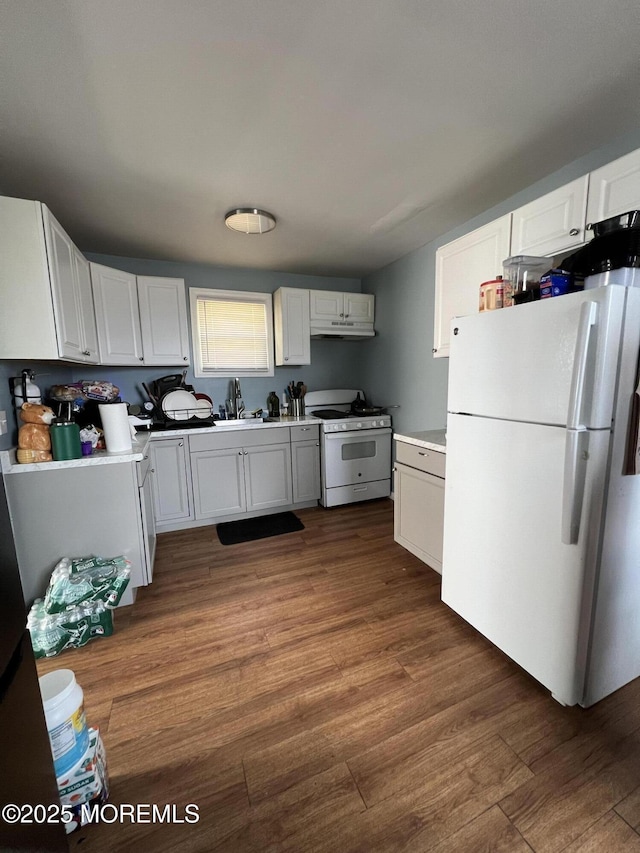 128 Hamilton Ave, Seaside Heights, NJ 08751 - kitchen featuring white appliances, under cabinet range hood, white cabinets, and dark wood-style flooring