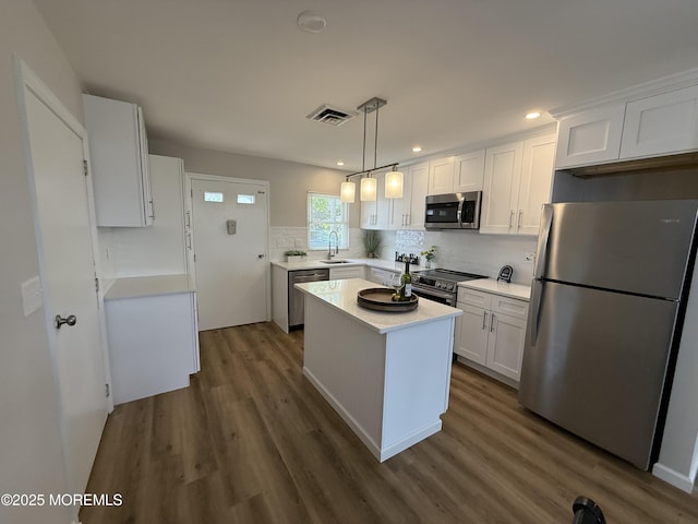 315D Coventry Ct Unit D, Lakewood, NJ 08701 - kitchen featuring appliances with stainless steel finishes, dark wood-style floors, backsplash, white cabinetry, and recessed lighting