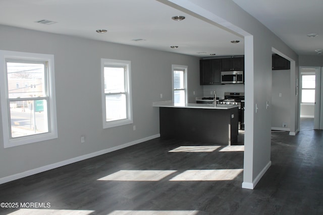 519 Roosevelt Ave, Carteret, NJ 07008 - kitchen featuring appliances with stainless steel finishes, baseboards, dark wood-type flooring, light countertops, and recessed lighting