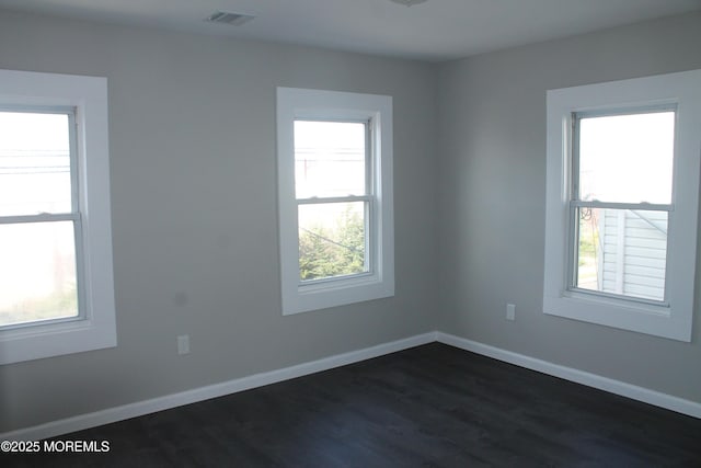 519 Roosevelt Ave, Carteret, NJ 07008 - spare room featuring plenty of natural light, dark wood-type flooring, and baseboards