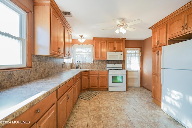 18 Lillie Rd, Toms River, NJ 08753 - kitchen featuring white appliances, a sink, decorative backsplash, a ceiling fan, and plenty of natural light