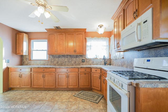 18 Lillie Rd, Toms River, NJ 08753 - kitchen with white appliances, a sink, tasteful backsplash, brown cabinets, and plenty of natural light