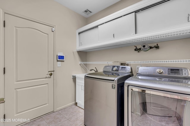 25 Bellflower Dr, Lakewood, NJ 08701 - laundry area with washing machine and dryer, light tile patterned flooring, cabinet space, and baseboards