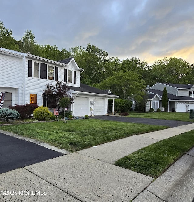 25 Atlantis Ter, Freehold, NJ 07728 - view of front of property with asphalt driveway and a yard