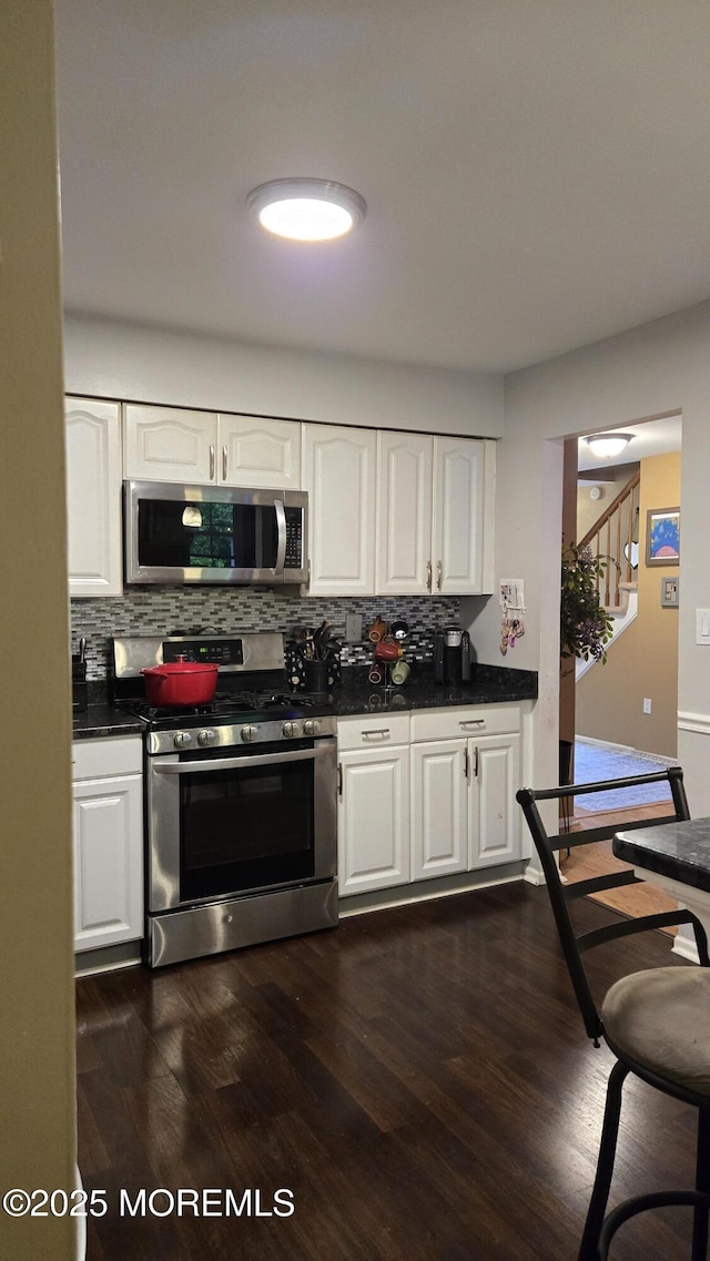25 Atlantis Ter, Freehold, NJ 07728 - kitchen with appliances with stainless steel finishes, decorative backsplash, dark countertops, and white cabinets