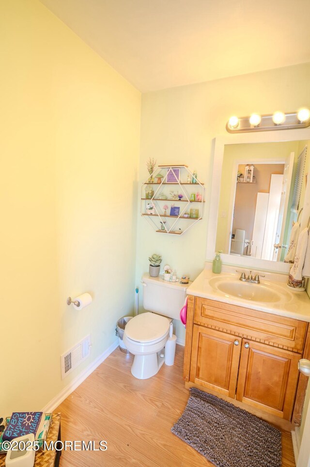 25 Atlantis Ter, Freehold, NJ 07728 - bathroom featuring toilet, vanity, wood finished floors, and baseboards