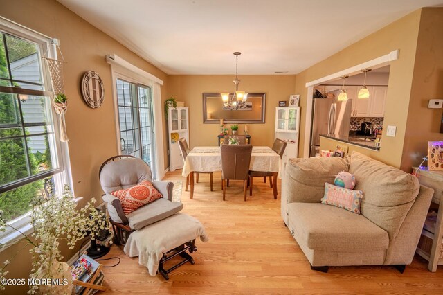 25 Atlantis Ter, Freehold, NJ 07728 - living room with a chandelier and light wood-style floors