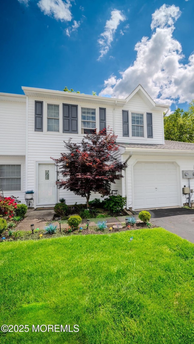25 Atlantis Ter, Freehold, NJ 07728 - view of front facade featuring a front yard, asphalt driveway, and an attached garage
