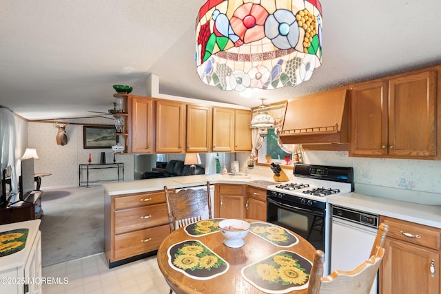 39 Marcia Memorial Cir, Jackson, NJ 08527 - kitchen featuring light countertops, gas range, lofted ceiling, wallpapered walls, and a peninsula