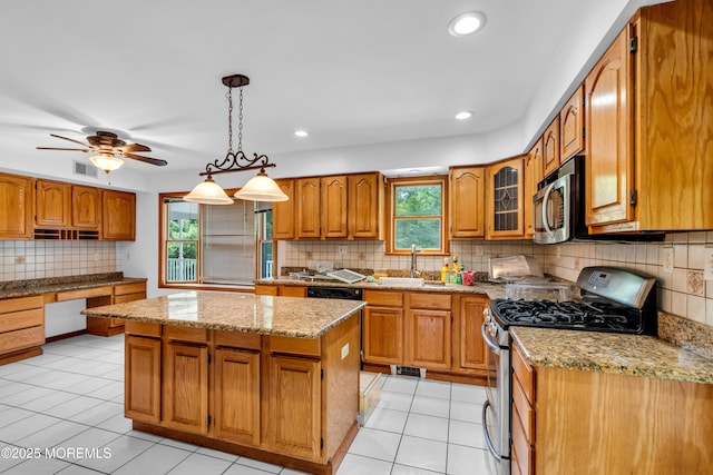 668 Hyson Rd, Jackson, NJ 08527 - kitchen featuring stainless steel appliances, brown cabinetry, tasteful backsplash, light stone countertops, and a center island