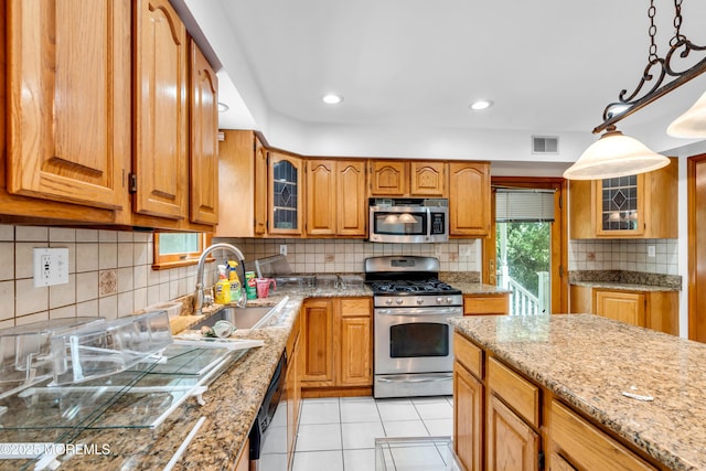 668 Hyson Rd, Jackson, NJ 08527 - kitchen featuring appliances with stainless steel finishes, a sink, brown cabinets, tasteful backsplash, and recessed lighting