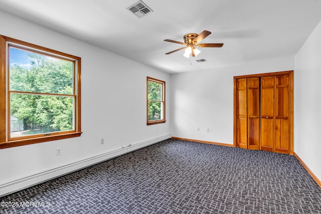 668 Hyson Rd, Jackson, NJ 08527 - unfurnished bedroom with dark colored carpet, baseboards, a closet, ceiling fan, and a baseboard heating unit