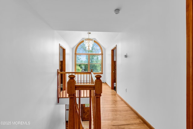 668 Hyson Rd, Jackson, NJ 08527 - hallway featuring an upstairs landing, a chandelier, light wood-style floors, lofted ceiling, and baseboards