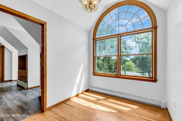 668 Hyson Rd, Jackson, NJ 08527 - unfurnished room with a baseboard heating unit, vaulted ceiling, light wood-type flooring, a chandelier, and baseboards