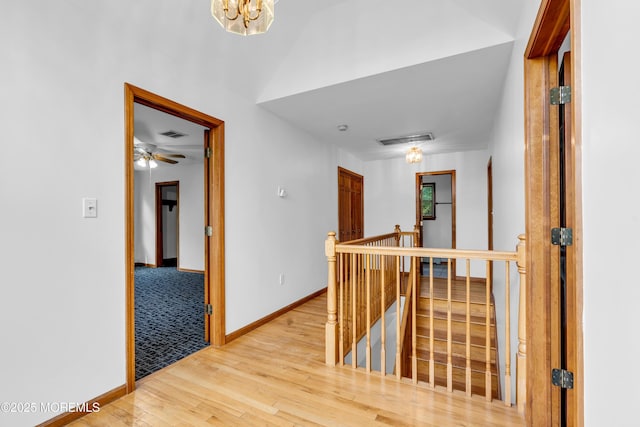 668 Hyson Rd, Jackson, NJ 08527 - hall with an upstairs landing, light wood-type flooring, a chandelier, and baseboards