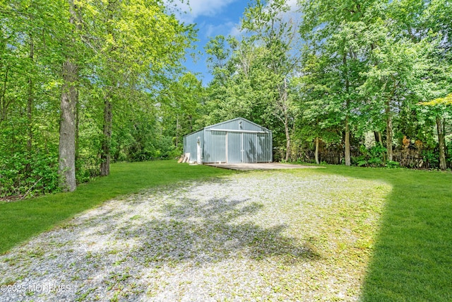 668 Hyson Rd, Jackson, NJ 08527 - view of grassy yard with a detached garage, an outbuilding, an outdoor structure, and driveway
