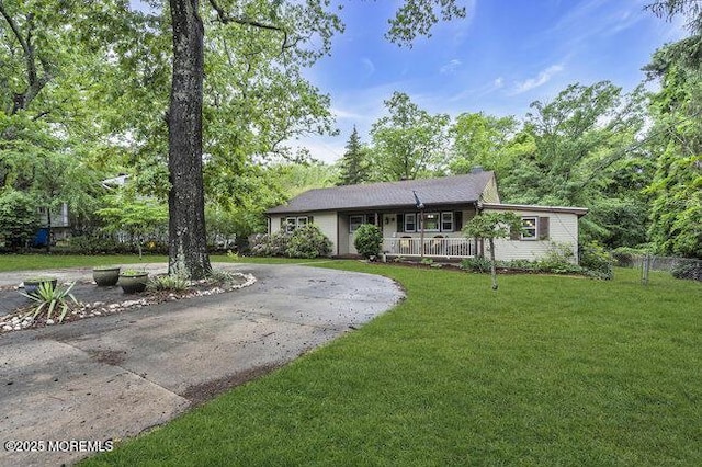 24 Delaware Trl, Browns Mills, NJ 08015 - single story home with curved driveway, a front yard, and a porch