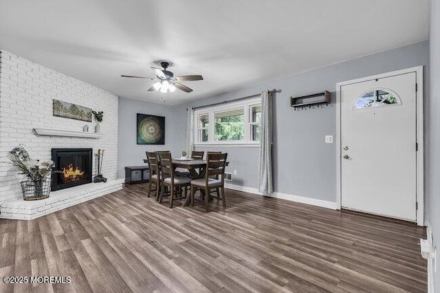 24 Delaware Trl, Browns Mills, NJ 08015 - dining space featuring a ceiling fan, wood finished floors, a brick fireplace, and baseboards