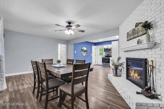 24 Delaware Trl, Browns Mills, NJ 08015 - dining area featuring a brick fireplace, ceiling fan, wood finished floors, and baseboards
