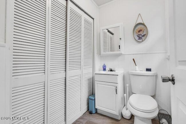 24 Delaware Trl, Browns Mills, NJ 08015 - bathroom featuring a closet, vanity, toilet, ornamental molding, and wainscoting