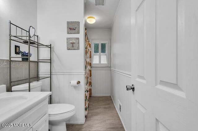 24 Delaware Trl, Browns Mills, NJ 08015 - bathroom featuring vanity, toilet, a wainscoted wall, ornamental molding, and curtained shower