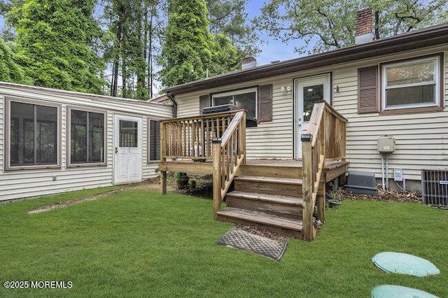 24 Delaware Trl, Browns Mills, NJ 08015 - back of property featuring a chimney, a lawn, a deck, and central air condition unit