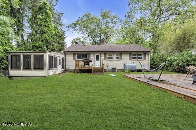 24 Delaware Trl, Browns Mills, NJ 08015 - back of property featuring a deck, heating fuel, a sunroom, and a lawn
