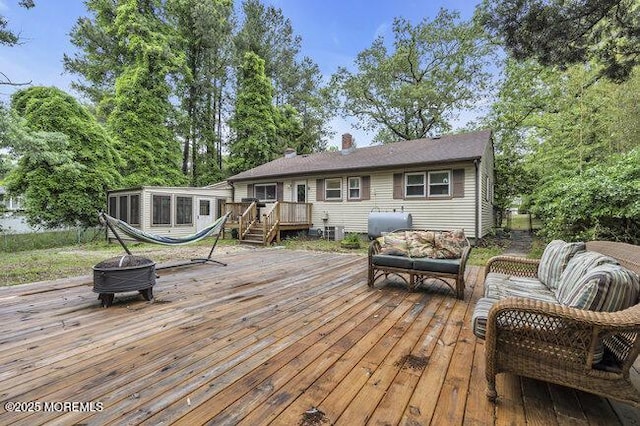 24 Delaware Trl, Browns Mills, NJ 08015 - wooden terrace featuring oil tank, an outdoor living space with a fire pit, and a sunroom