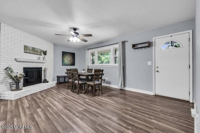 24 Delaware Trl, Browns Mills, NJ 08015 - dining room with a ceiling fan, wood finished floors, baseboards, and a brick fireplace