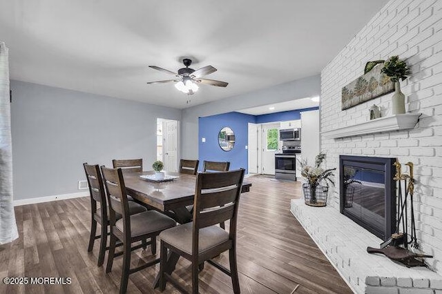 24 Delaware Trl, Browns Mills, NJ 08015 - dining room with a fireplace, ceiling fan, wood finished floors, and baseboards