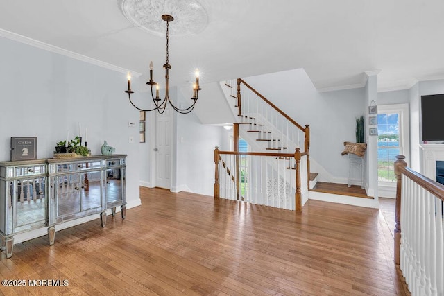 332 Seaview Cir, Neptune Township, NJ 07753 - dining space featuring wood finished floors, crown molding, stairs, baseboards, and a chandelier