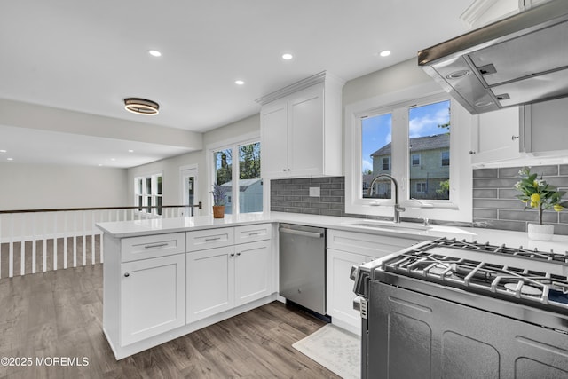 18 Heritage Dr, Edison, NJ 08820 - kitchen with dishwasher, exhaust hood, range with gas cooktop, a peninsula, and white cabinetry