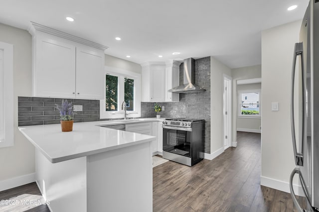 18 Heritage Dr, Edison, NJ 08820 - kitchen with wall chimney range hood, appliances with stainless steel finishes, healthy amount of natural light, a peninsula, and recessed lighting