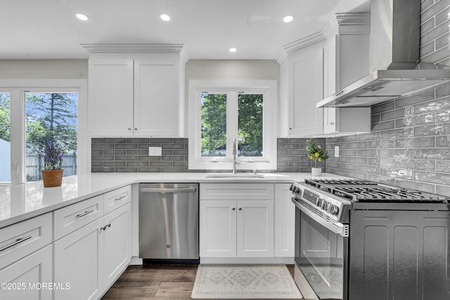 18 Heritage Dr, Edison, NJ 08820 - kitchen featuring appliances with stainless steel finishes, wall chimney range hood, healthy amount of natural light, recessed lighting, and white cabinets