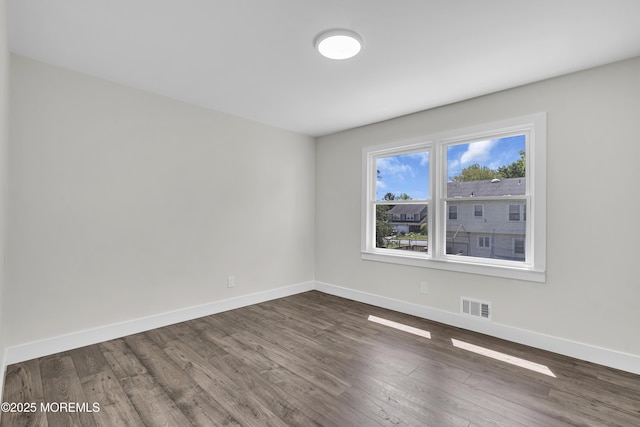 18 Heritage Dr, Edison, NJ 08820 - spare room with baseboards and dark wood-style flooring