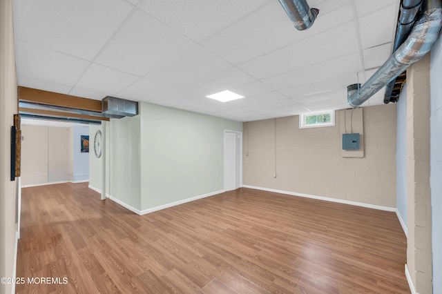 208 Bradwick Way, Marlboro, NJ 07746 - basement with light wood finished floors, a drop ceiling, electric panel, and baseboards