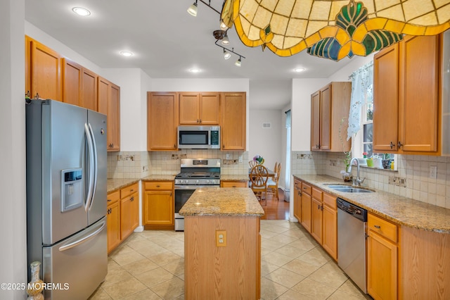 208 Bradwick Way, Marlboro, NJ 07746 - kitchen with stainless steel appliances, a sink, a kitchen island, tasteful backsplash, and light stone countertops