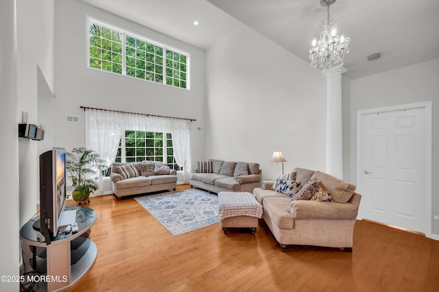 208 Bradwick Way, Marlboro, NJ 07746 - living area with a towering ceiling, hardwood / wood-style floors, decorative columns, a chandelier, and recessed lighting