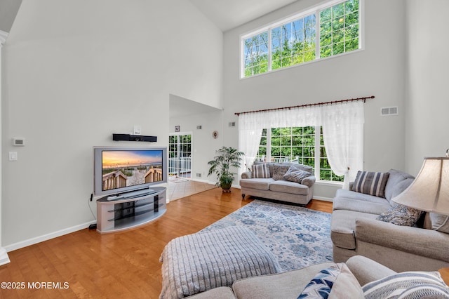 208 Bradwick Way, Marlboro, NJ 07746 - living room featuring high vaulted ceiling, baseboards, and wood finished floors
