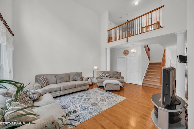 208 Bradwick Way, Marlboro, NJ 07746 - living room with a high ceiling, stairway, light wood-style floors, and decorative columns