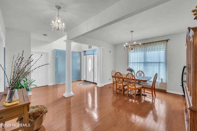 208 Bradwick Way, Marlboro, NJ 07746 - dining space with a chandelier, decorative columns, baseboards, and wood-type flooring