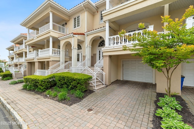 17 Riviera Dr, Long Branch, NJ 07740 - view of front of property featuring an attached garage, stucco siding, and stairs