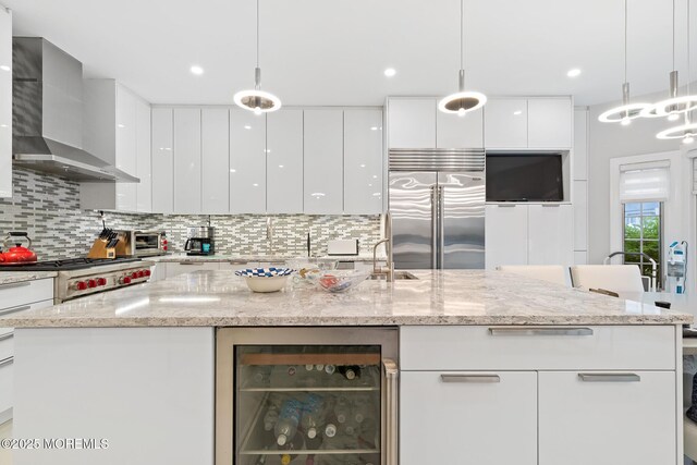 17 Riviera Dr, Long Branch, NJ 07740 - kitchen featuring modern cabinets, built in fridge, wine cooler, wall chimney range hood, and white cabinets