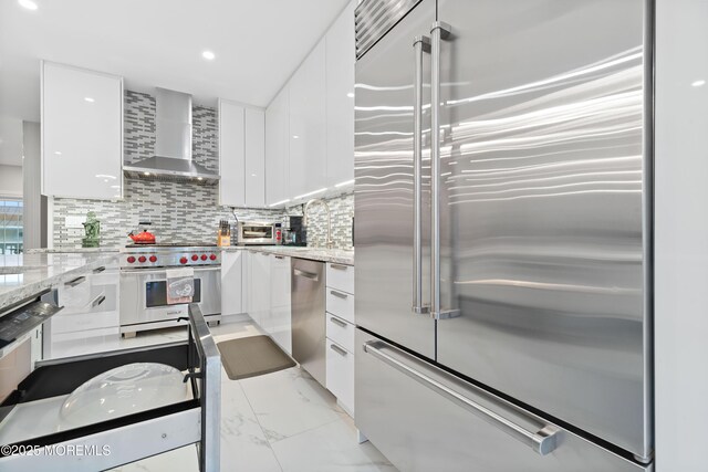 17 Riviera Dr, Long Branch, NJ 07740 - kitchen featuring high end appliances, wall chimney range hood, modern cabinets, white cabinetry, and recessed lighting