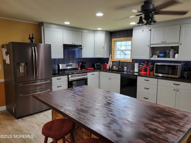 157 Taylors Mills Rd, Englishtown, NJ 07726 - kitchen with appliances with stainless steel finishes, under cabinet range hood, a sink, decorative backsplash, and recessed lighting