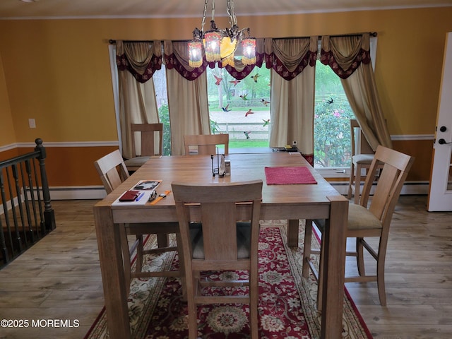 157 Taylors Mills Rd, Englishtown, NJ 07726 - dining area with a baseboard heating unit, a chandelier, plenty of natural light, wood finished floors, and ornamental molding