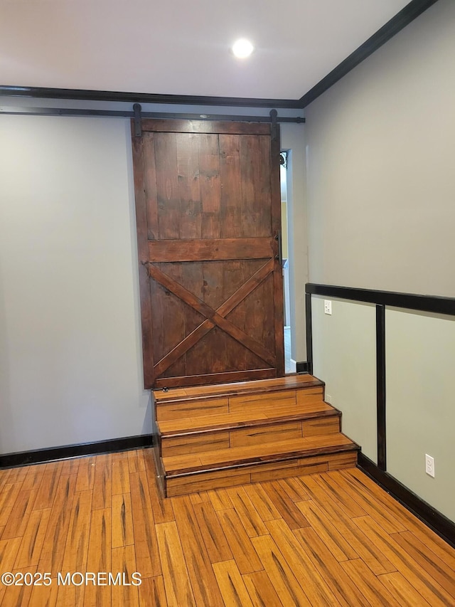 157 Taylors Mills Rd, Englishtown, NJ 07726 - staircase with a barn door, wood finished floors, crown molding, baseboards, and recessed lighting