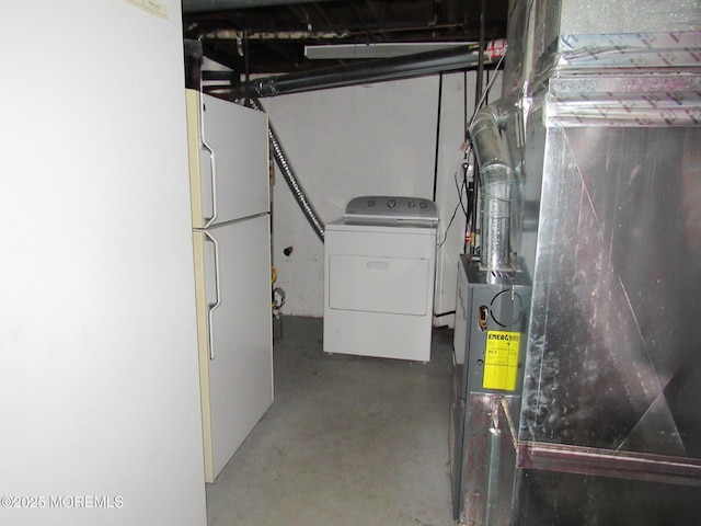 710 Baltic Dr, Brick, NJ 08723 - unfinished below grade area featuring washer / clothes dryer, freestanding refrigerator, and heating unit