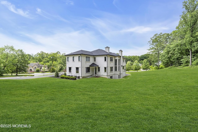 30 Winchester Ln, Holmdel, NJ 07733 - view of front of house with a chimney, a front lawn, and stucco siding